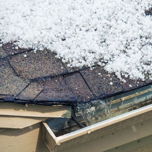 A Roof Covered in Hailstones damage that can be handled by a residential roofer