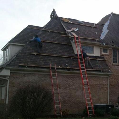 Roofers Work on an Asphalt Shingle Roof.