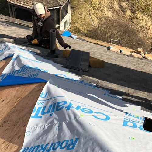 A Roofer Works on a Roof Installation.