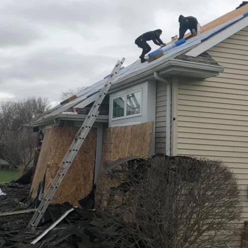 Roofers Repair a Roof.